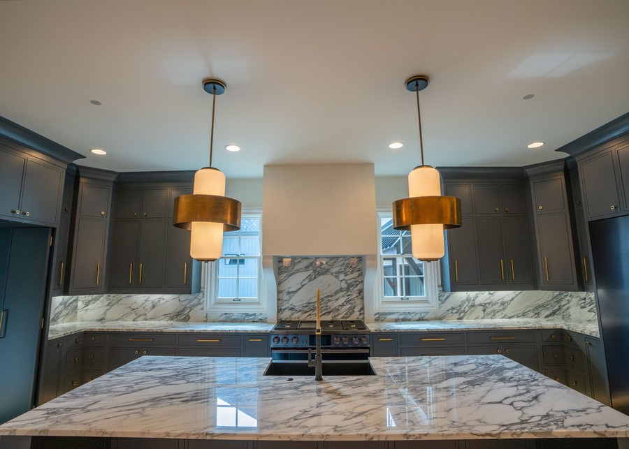 Small circular aperture speakers by James Loudspeaker above a large kitchen island