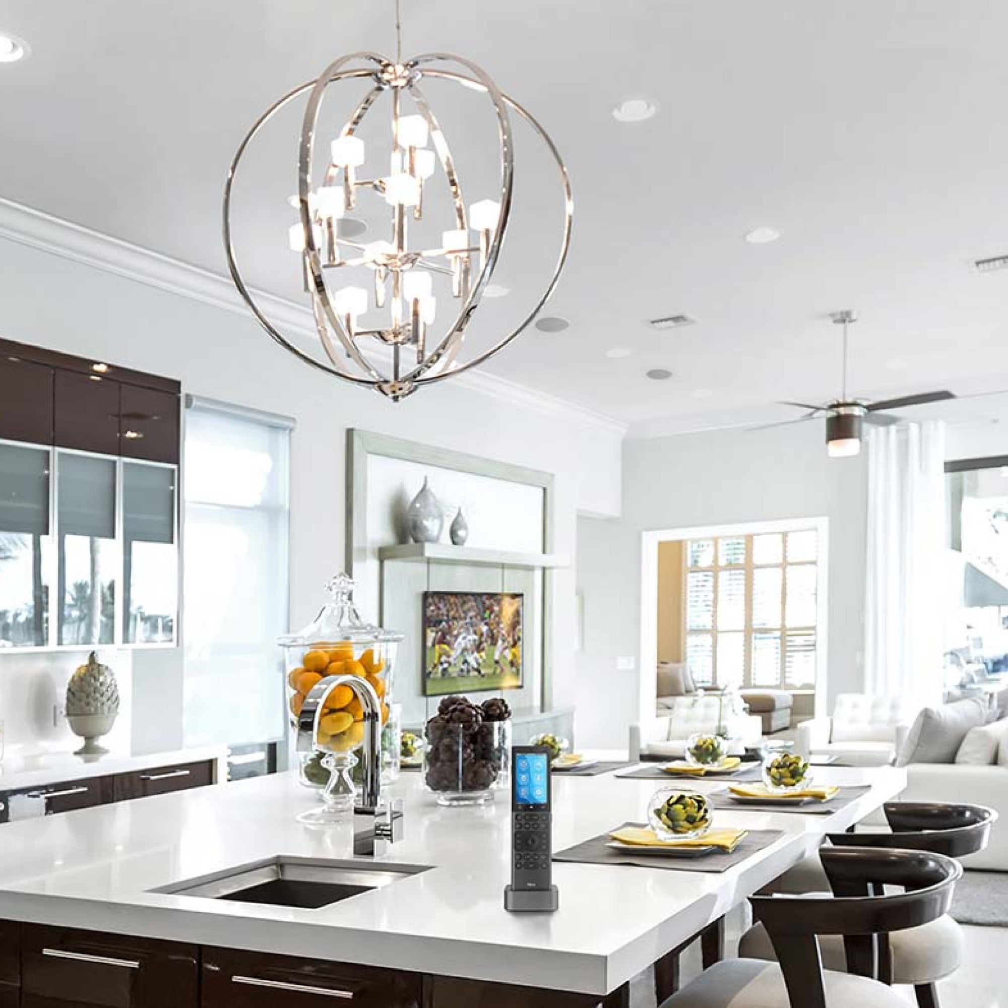 Bright white kitchen with speakers and recessed lighting in the ceiling